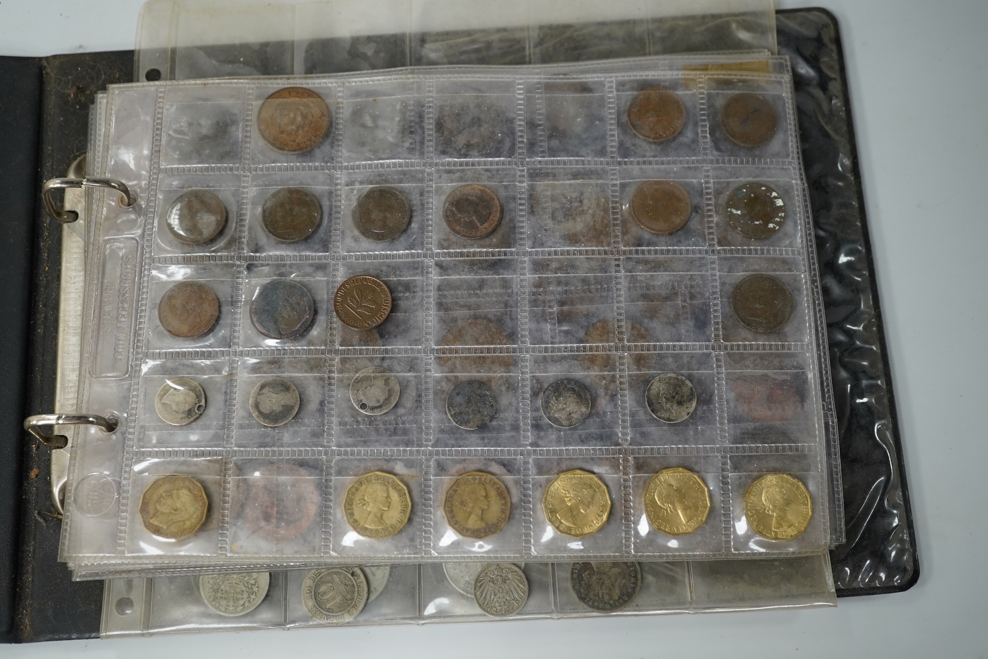A collection of various coinage in an album, mostly George V to QEII